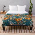 Boho sloth floral plush blanket with teal and orange pattern