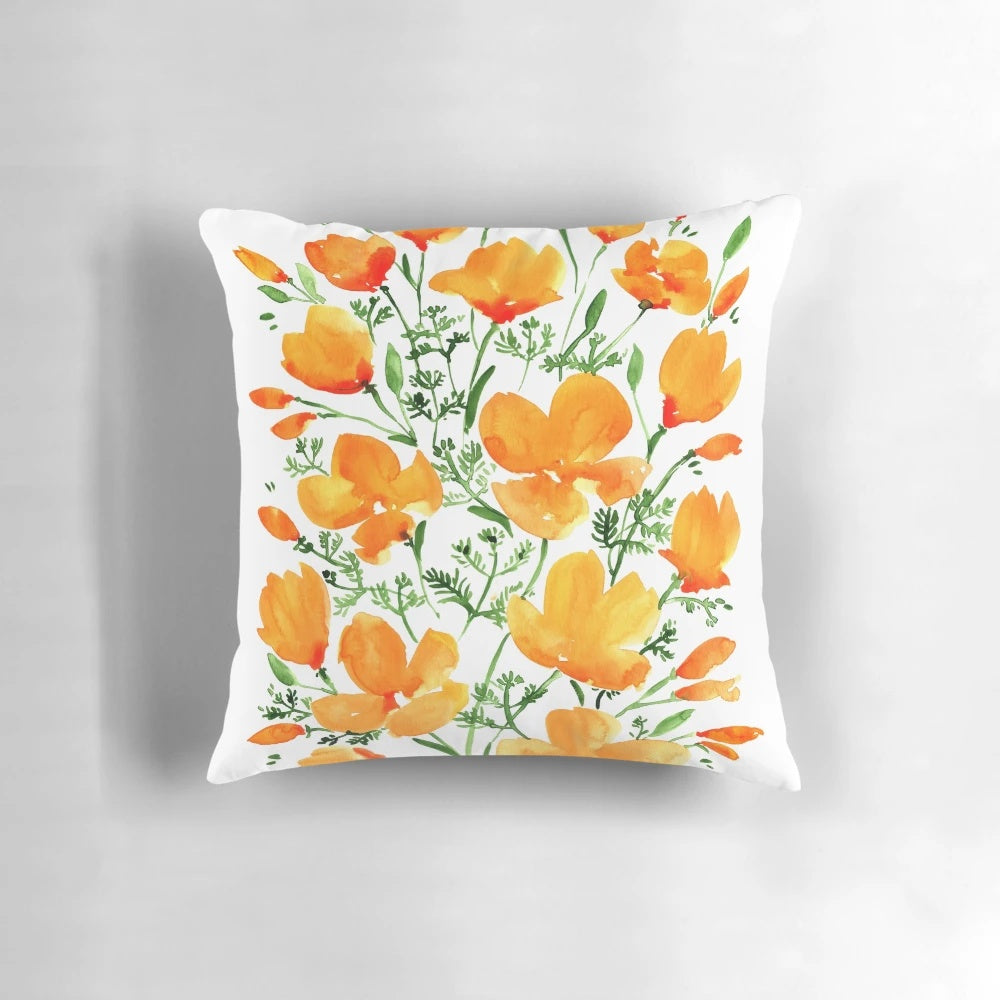 Watercolor painting of vibrant California poppies on a decorative throw pillow