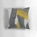 A Pillow featuring a bold, abstract art design in black, yellow, and gray with paint splash and streaks.