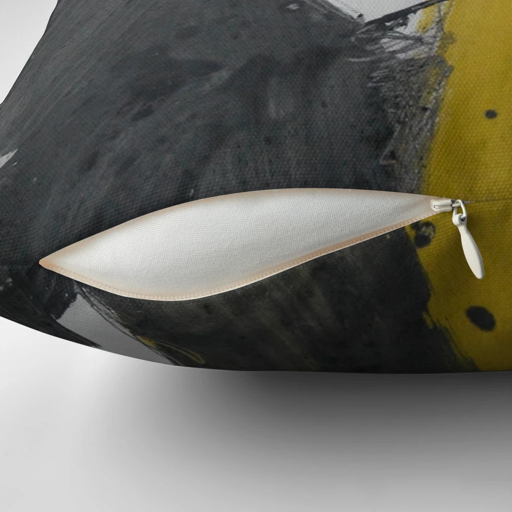 A Pillow featuring a bold, abstract art design in black, yellow, and gray with paint splash and streaks.
