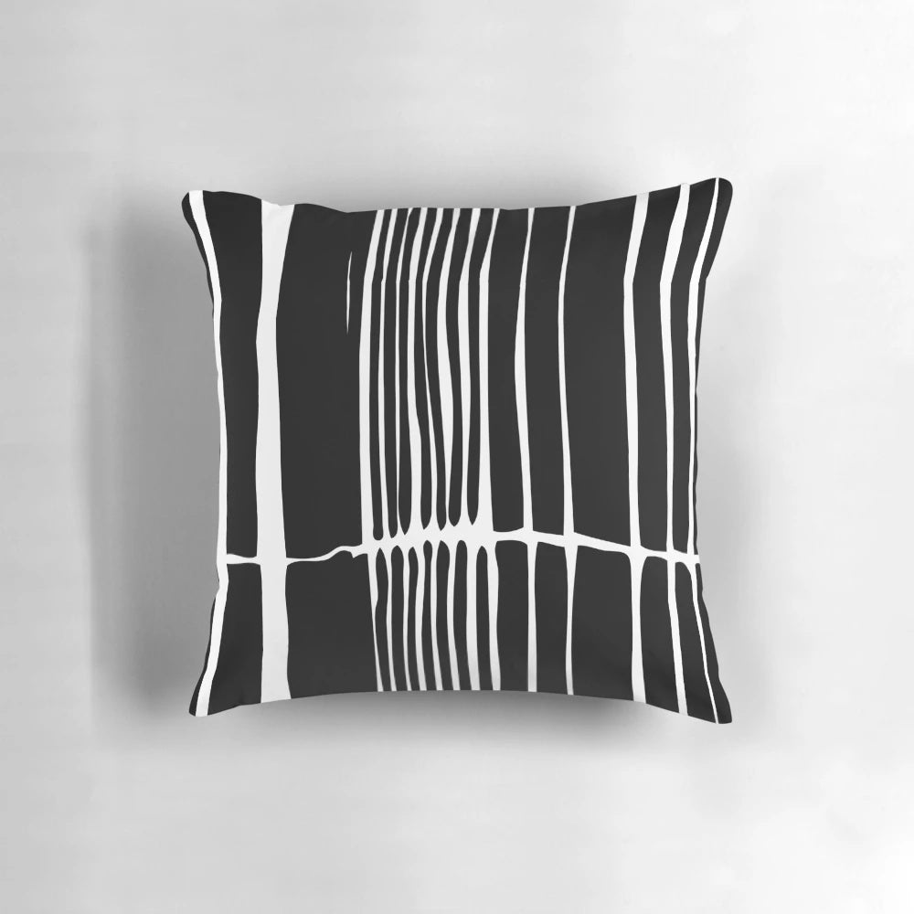 Abstract black and white striped pillow with a bold, linear pattern for modern, minimalist home decor.
