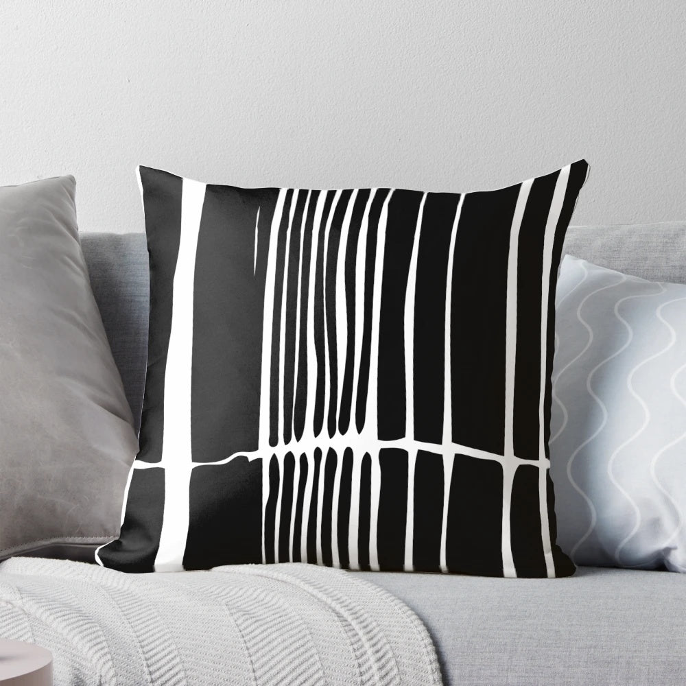 Abstract black and white striped pillow with a bold, linear pattern for modern, minimalist home decor.