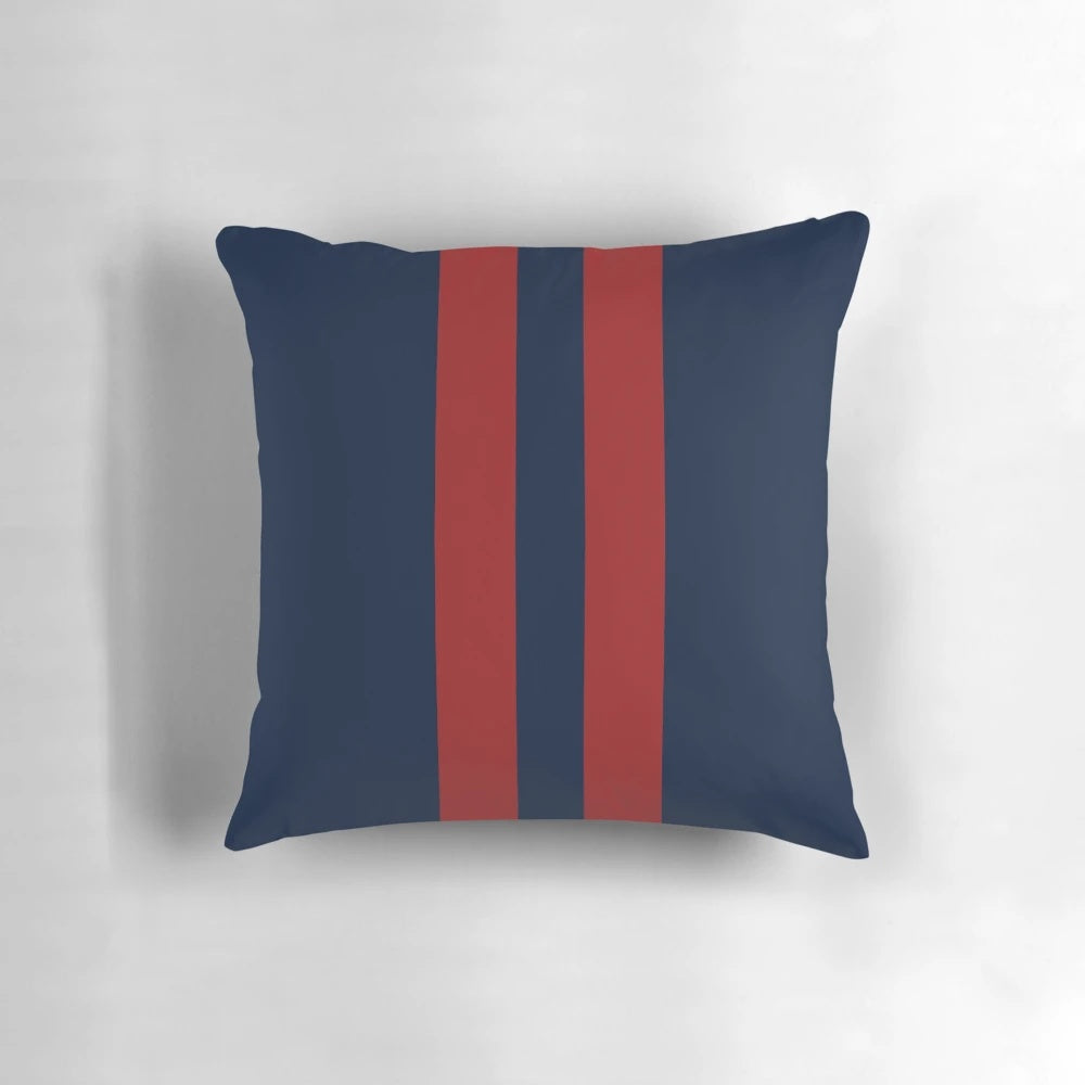 Navy blue and red striped throw pillow with bold vertical stripes
