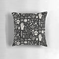 A black and white image of a bone black pillow, featuring a collection of natural elements like skulls, insects, and mushrooms.