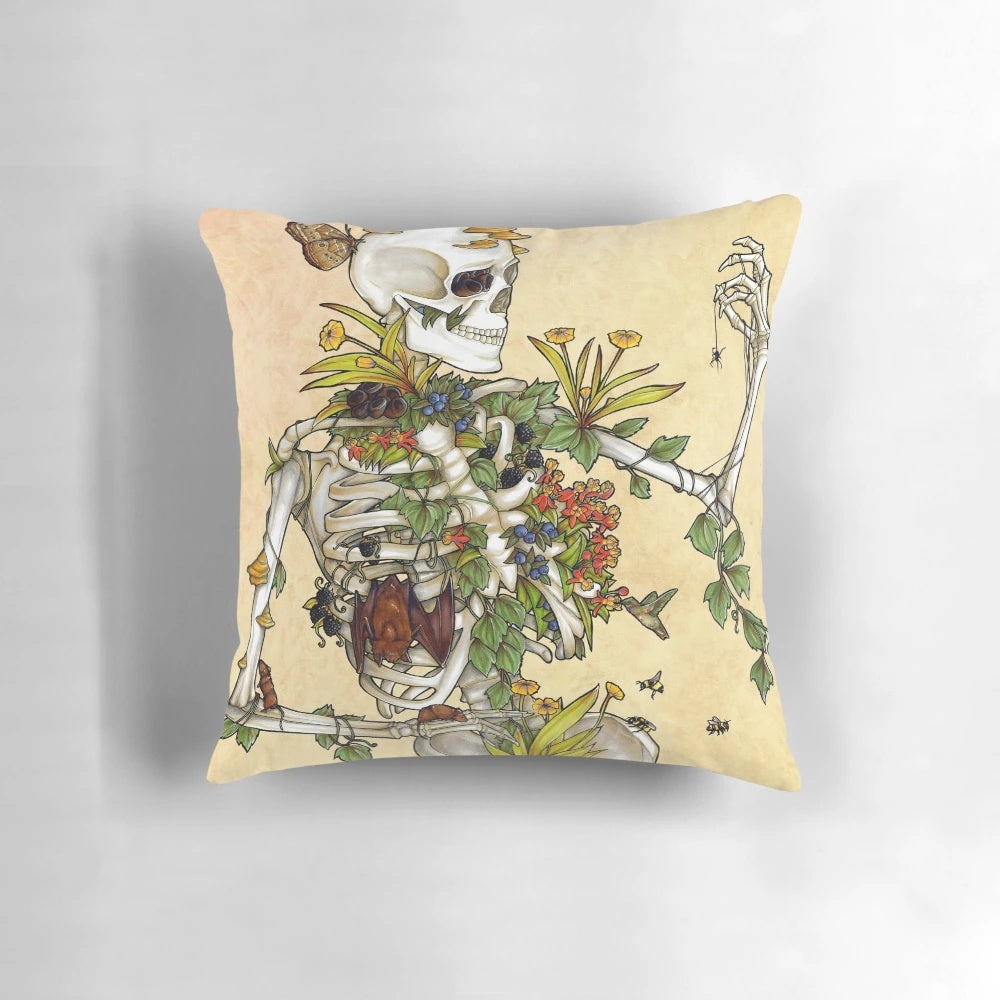Decorative pillow featuring a detailed illustration of a human skull surrounded by botanical elements like plants, flowers, and fungi.