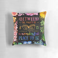 A black and multicolored watercolor floral pillow with a literary theme, perfect for book lovers and bibliophiles.