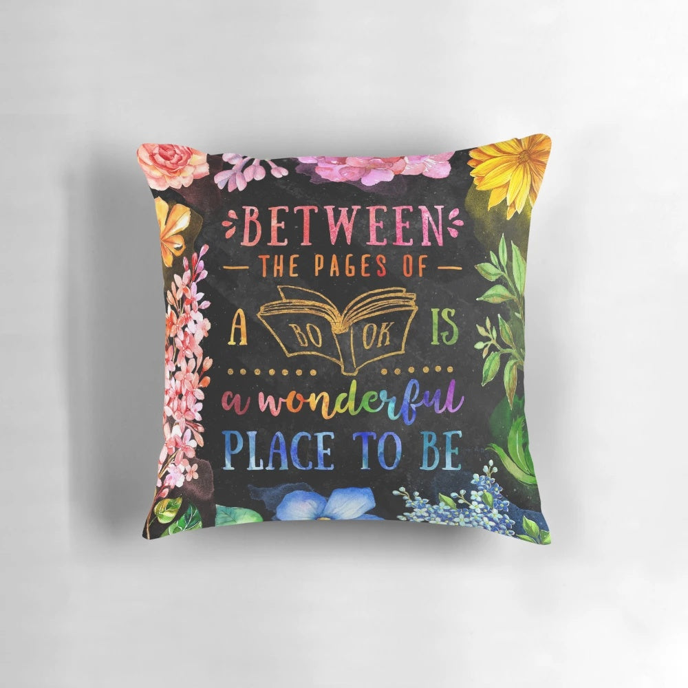 A black and multicolored watercolor floral pillow with a literary theme, perfect for book lovers and bibliophiles.