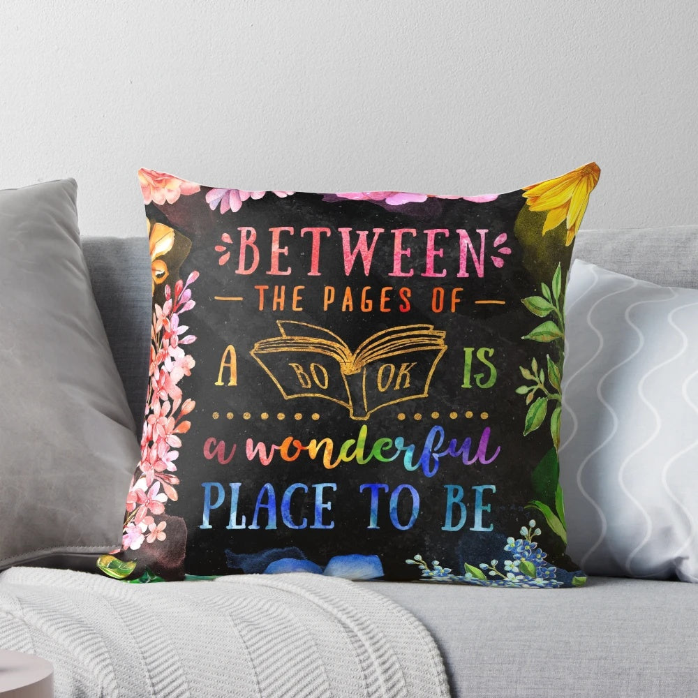 A black and multicolored watercolor floral pillow with a literary theme, perfect for book lovers and bibliophiles.
