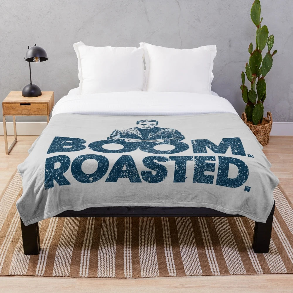 Plush blanket featuring a Michael Scott "Boom. Roasted." design inspired by the TV show The Office.