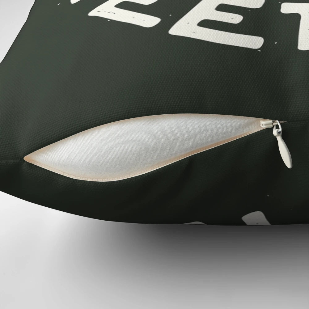 A white pillow with a dinosaur graphic and text reading "Stuck in Meetings