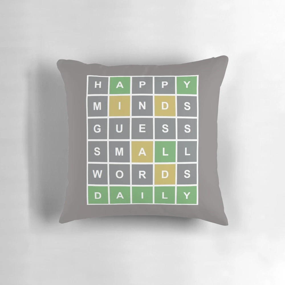 Colorful pillow featuring a Wordle-style game grid with letters