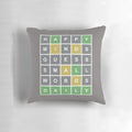 Colorful pillow featuring a Wordle-style game grid with letters