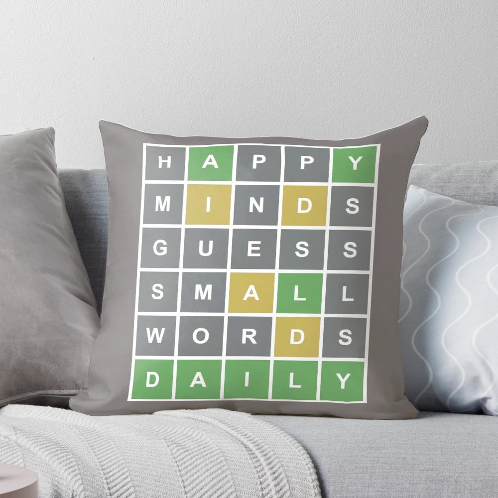 Colorful pillow featuring a Wordle-style game grid with letters