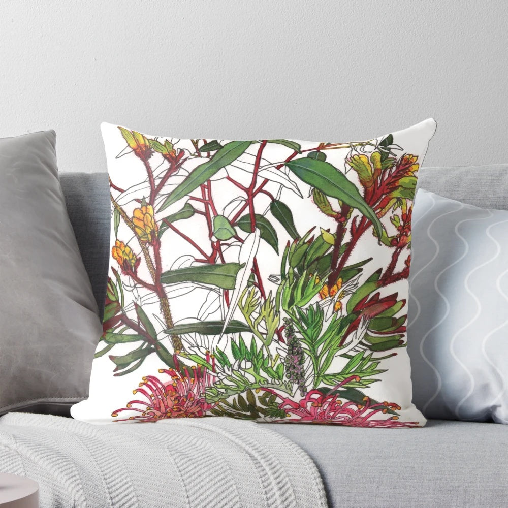 Colorful arrangement of Australian native flowers including kangaroo paw, protea, and eucalyptus leaves on a pillow.