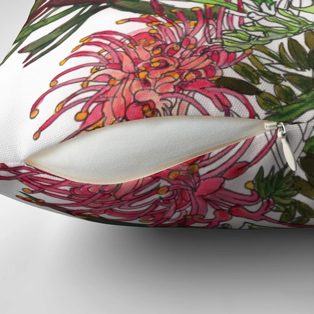 Colorful arrangement of Australian native flowers including kangaroo paw, protea, and eucalyptus leaves on a pillow.