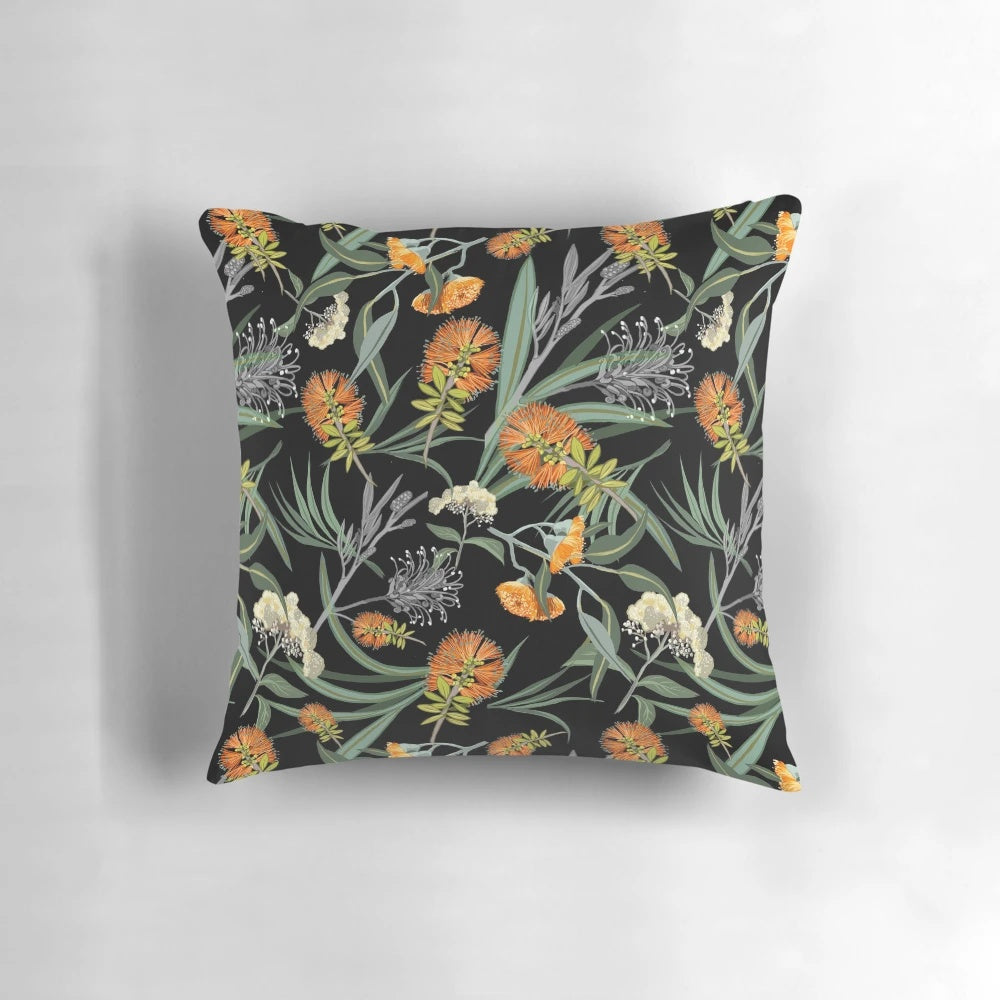 Botanical pillow featuring an orange and white pattern of Australian native banksia flowers and foliage.