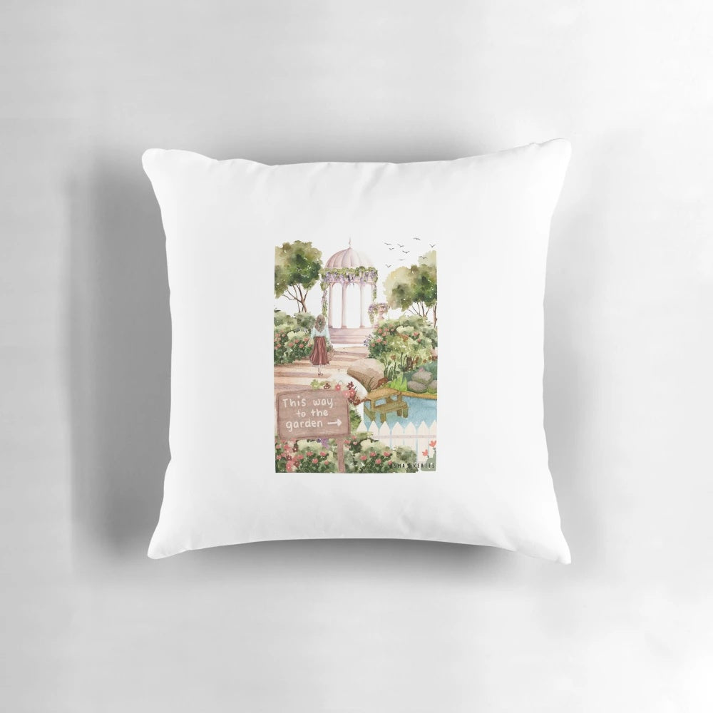 Decorative throw pillow featuring a watercolor painting of a birdcage in a lush garden setting