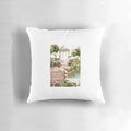 Decorative throw pillow featuring a watercolor painting of a birdcage in a lush garden setting
