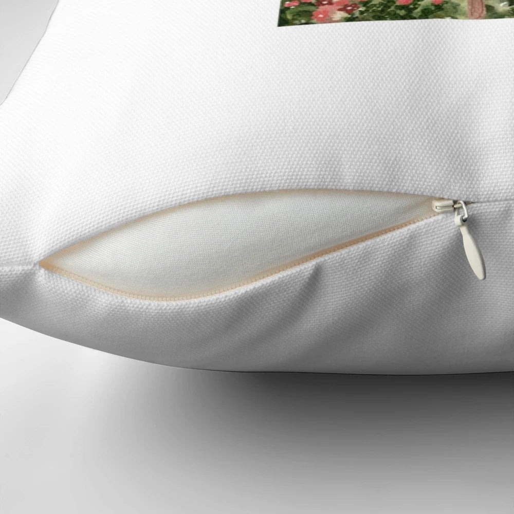 Decorative throw pillow featuring a watercolor painting of a birdcage in a lush garden setting