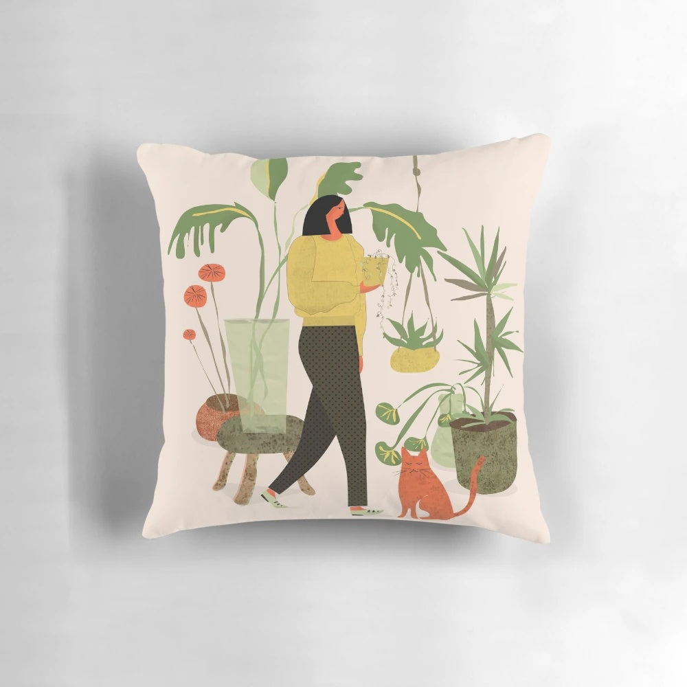A cozy plant-themed pillow featuring a ginger cat lounging amidst a lush floral arrangement.