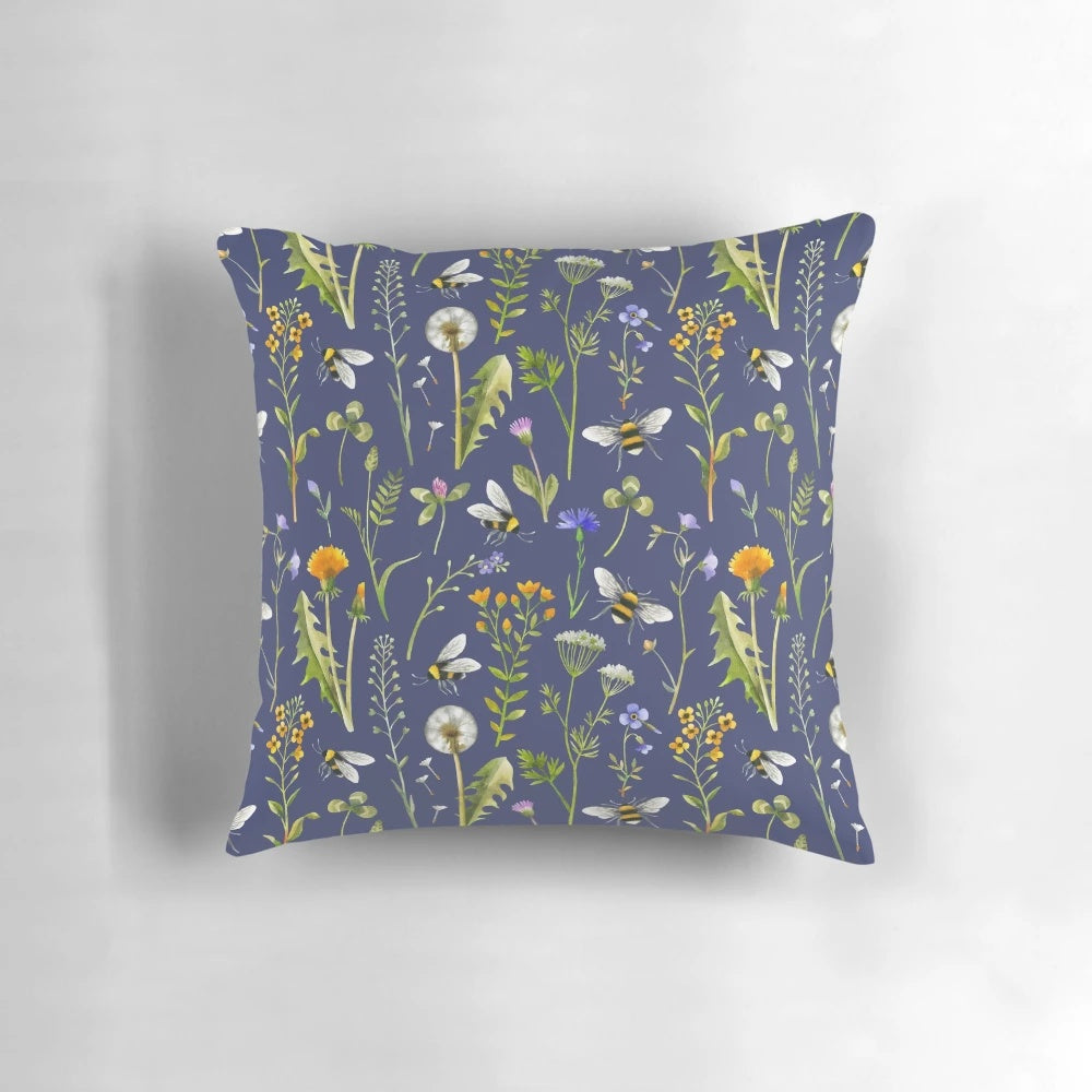 Beautifully detailed pillow featuring a charming illustration of bees pollinating vibrant wildflowers against a dark blue background.