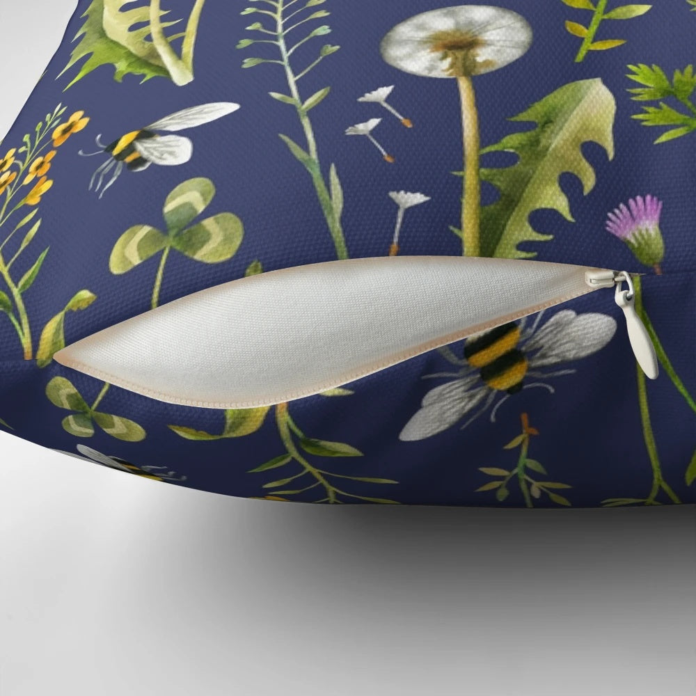 Beautifully detailed pillow featuring a charming illustration of bees pollinating vibrant wildflowers against a dark blue background.