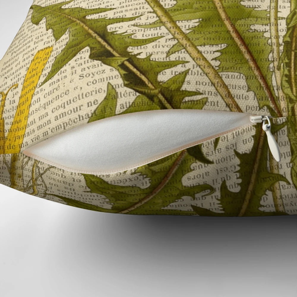 Pillow featuring a botanical print of dandelion flowers on an aged, vintage book page.