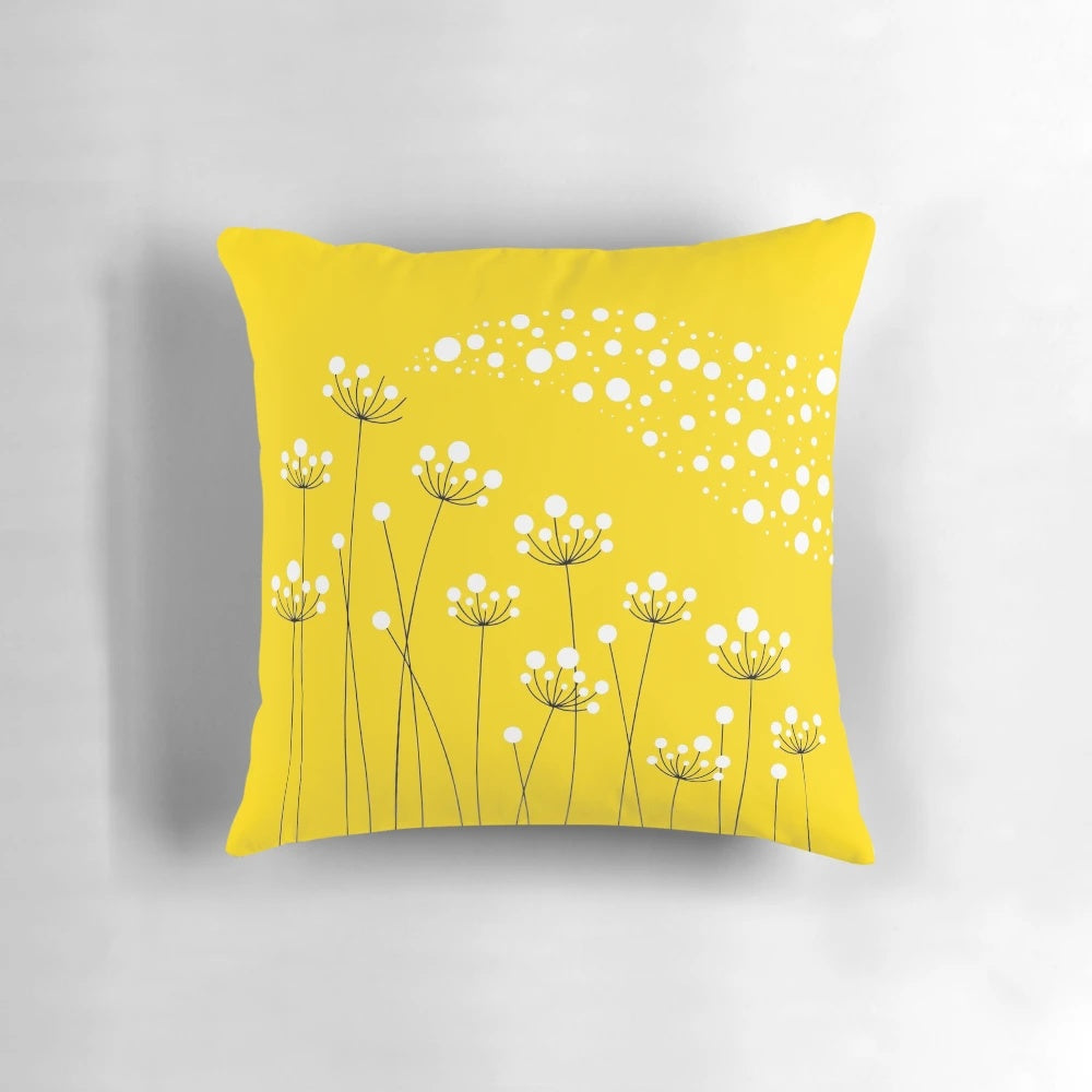 A stylish and minimalist throw pillow featuring a graphic design of dandelion silhouettes against a yellow background.