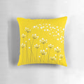 A stylish and minimalist throw pillow featuring a graphic design of dandelion silhouettes against a yellow background.