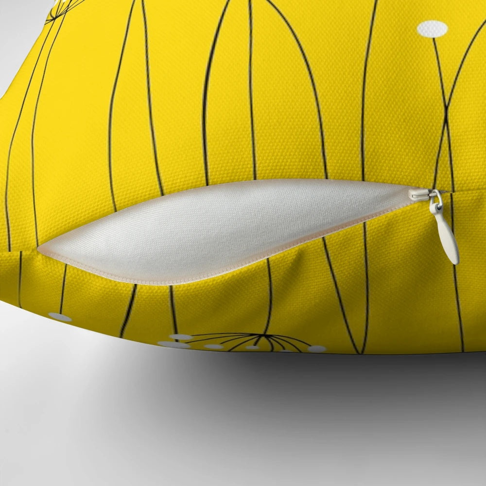 A stylish and minimalist throw pillow featuring a graphic design of dandelion silhouettes against a yellow background.