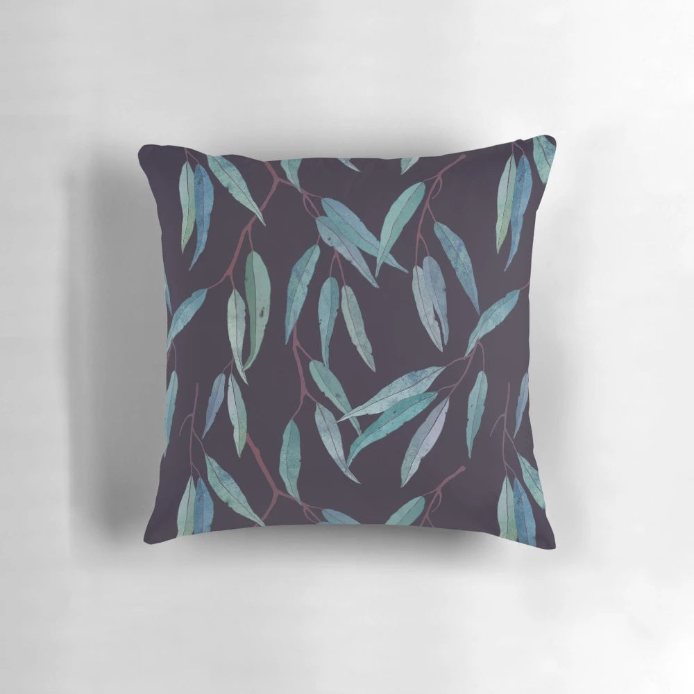 Closeup of a pillow covered in eucalyptus leaves, creating a serene and natural look.