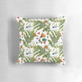 A watercolor painting of forest ferns, berries, and mushrooms on a decorative pillow.