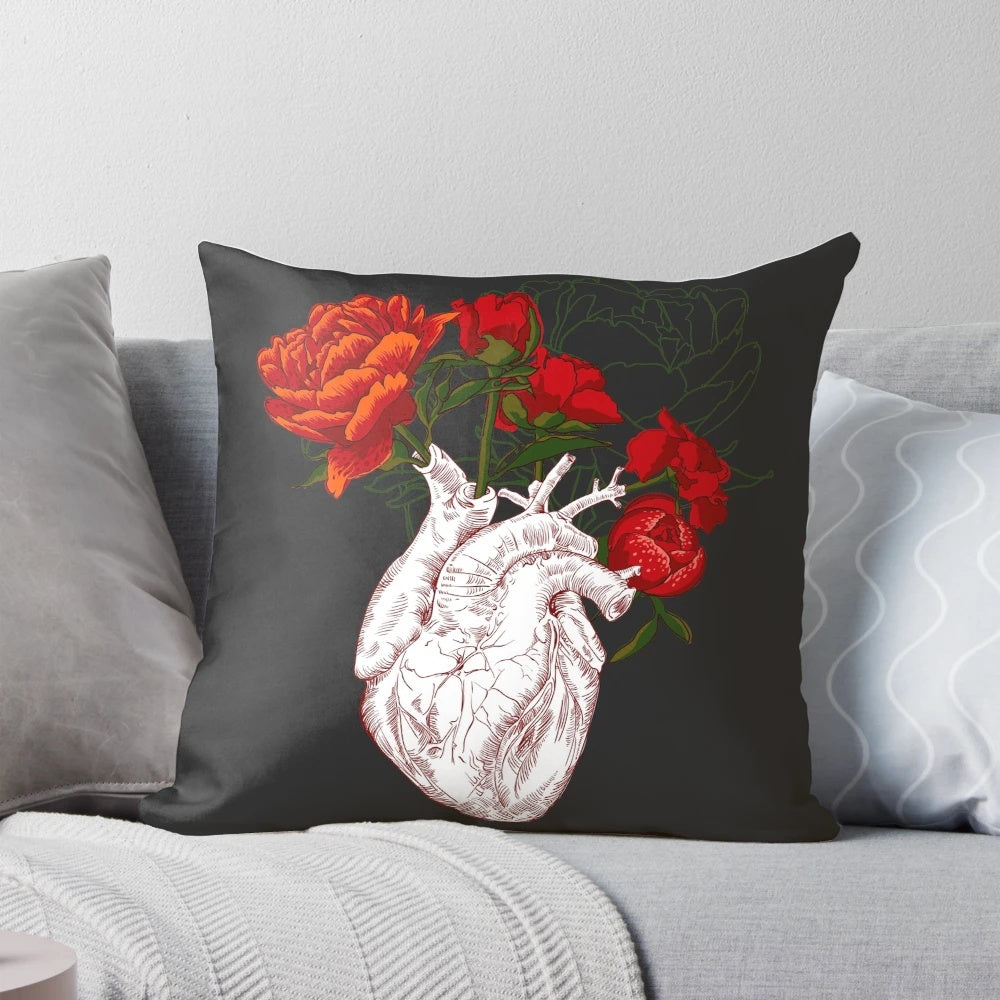 Decorative pillow featuring a detailed illustration of a human heart surrounded by delicate floral elements.