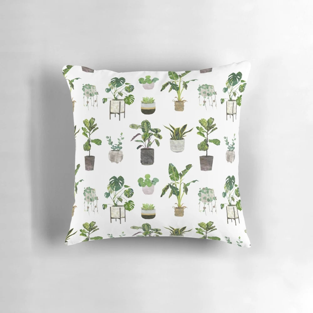 Decorative pillow featuring a botanical pattern of houseplants, succulents, and monstera leaves.