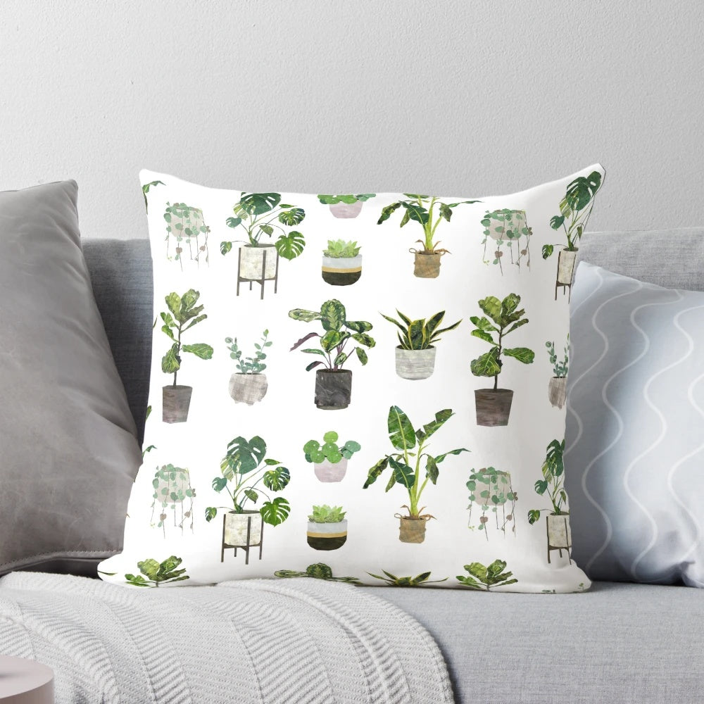 Decorative pillow featuring a botanical pattern of houseplants, succulents, and monstera leaves.