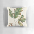 Decorative pillow featuring a watercolor illustration of oak leaves and acorns in autumn colors