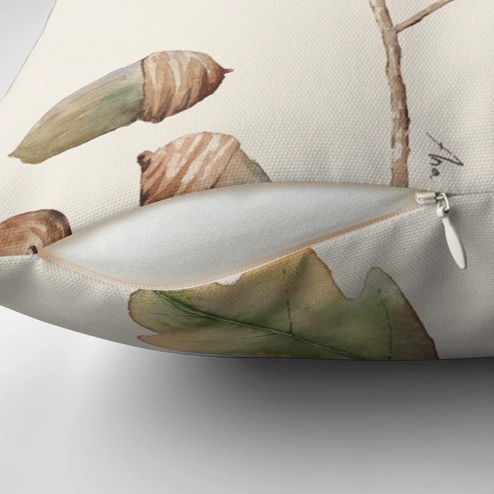 Decorative pillow featuring a watercolor illustration of oak leaves and acorns in autumn colors