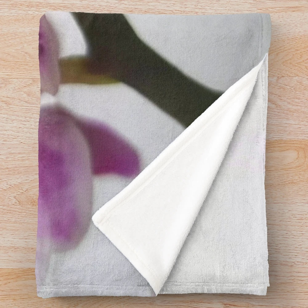 Soft and cozy plush blanket featuring a beautiful orchid design on a branch