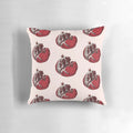 Detailed pen and ink sketch of a ripe, split open pomegranate on a decorative throw pillow.