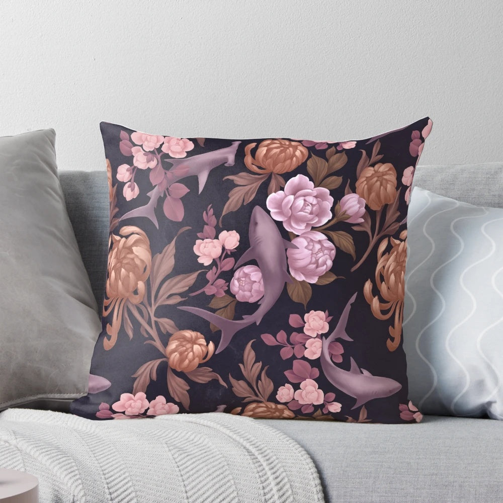 Botanical sharks and floral patterns in soft pink and rose gold colors on a decorative throw pillow.