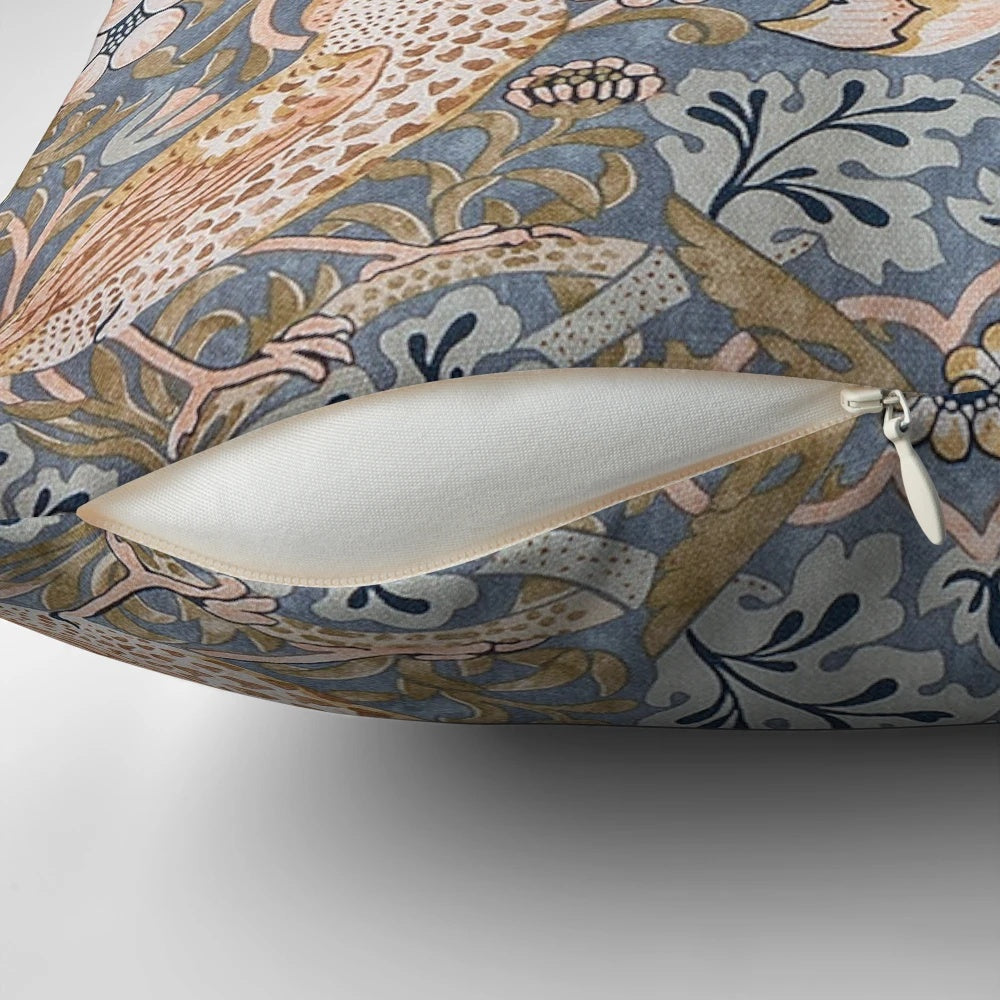 A close-up view of a decorative pillow featuring the iconic "Strawberry Thief" pattern designed by William Morris.