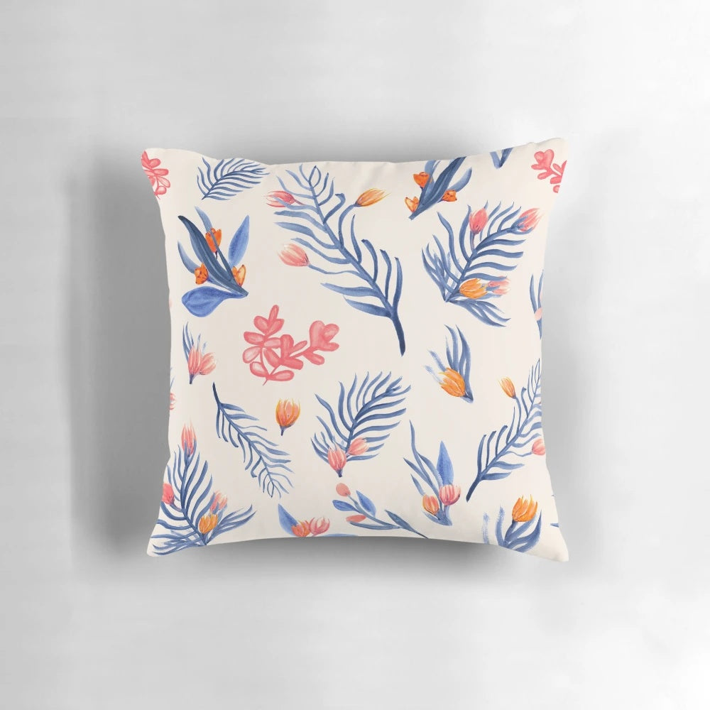 Cream-colored pillow with a vibrant succulent garden pattern in shades of blue, pink, and orange.