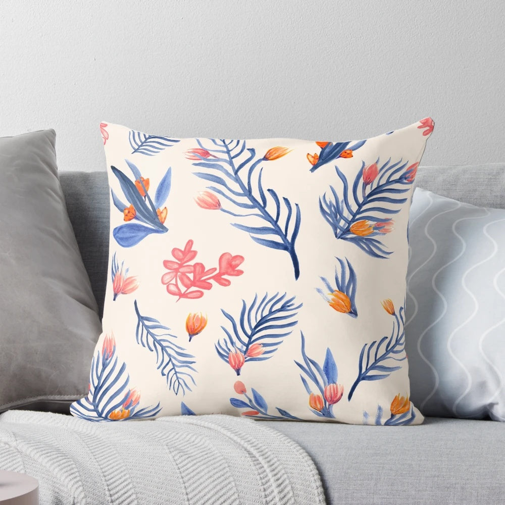 Cream-colored pillow with a vibrant succulent garden pattern in shades of blue, pink, and orange.