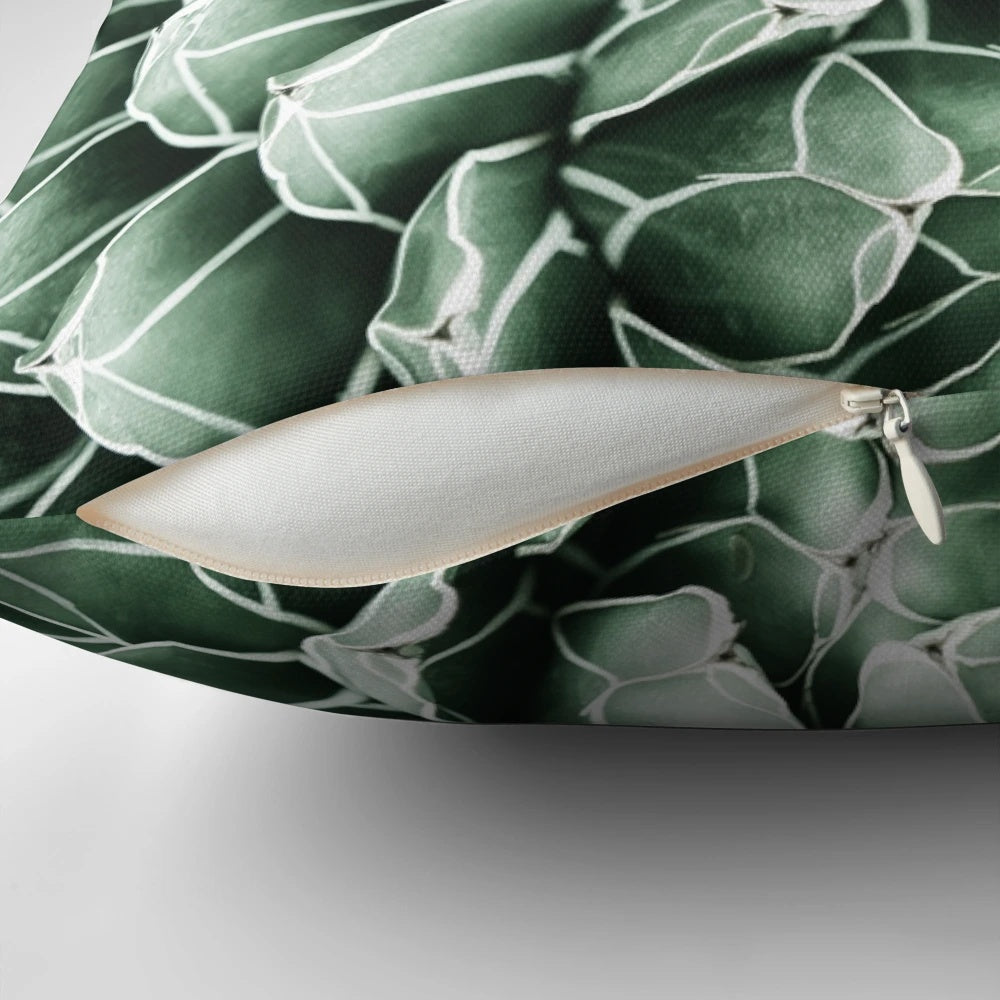 Lush green and neutral-toned succulent and botanical design on a soft, cozy pillow