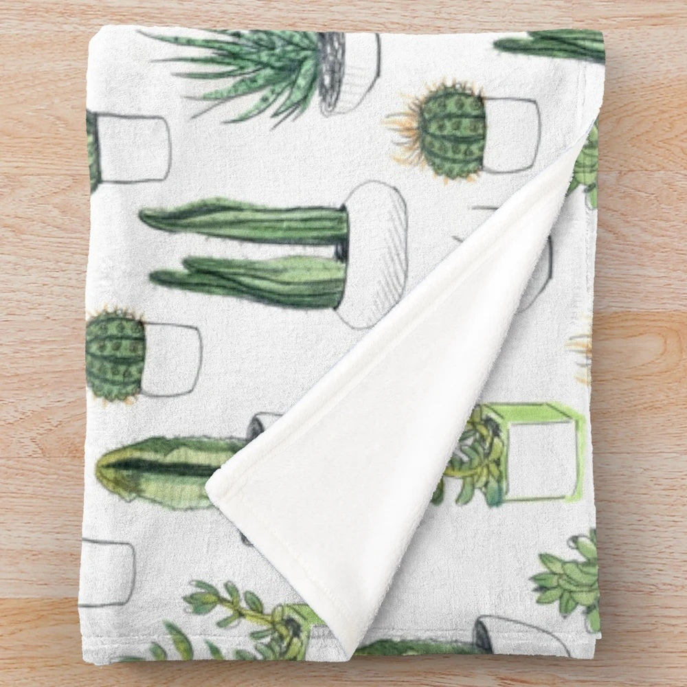 Watercolor cacti and succulents pattern on a plush blanket