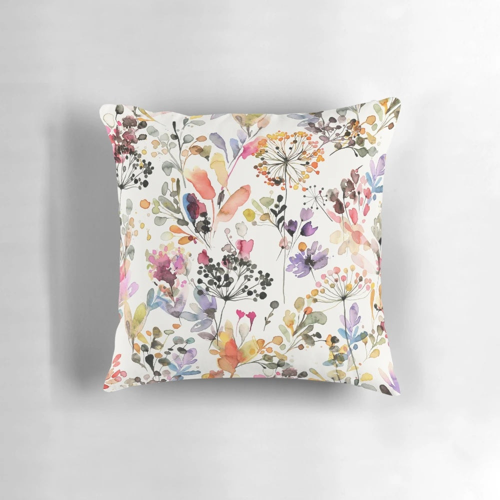 Vibrant watercolor painting of wild flowers and plants printed on a soft, plush pillow for a nature-inspired home accent.
