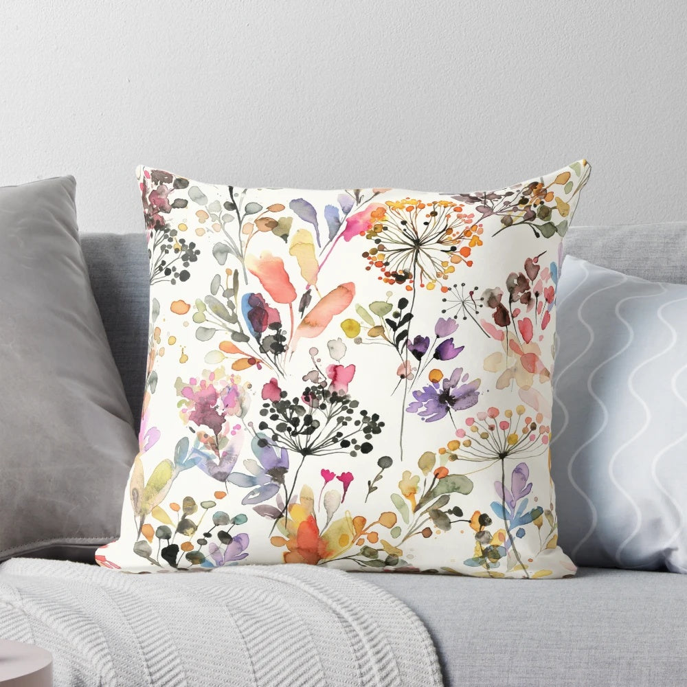 Vibrant watercolor painting of wild flowers and plants printed on a soft, plush pillow for a nature-inspired home accent.