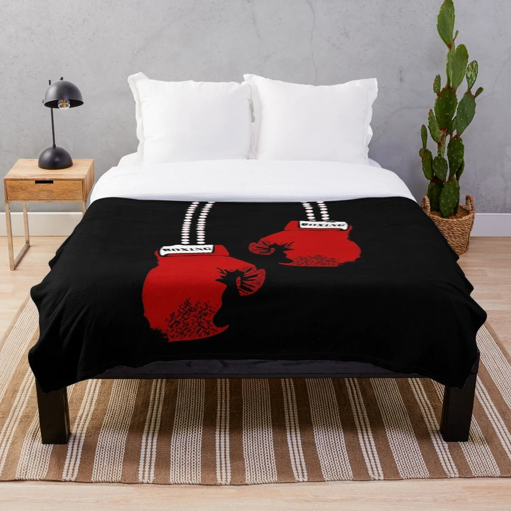 A cozy plush blanket featuring boxing gloves design for boxing enthusiasts