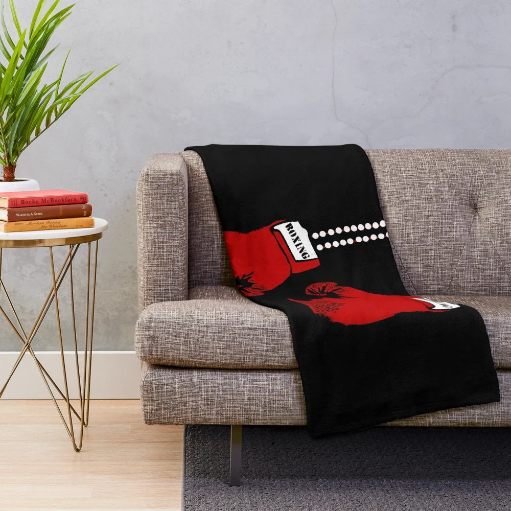 A cozy plush blanket featuring boxing gloves design for boxing enthusiasts
