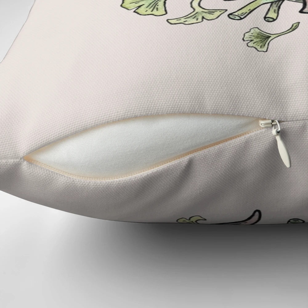 Brachiosaurus sauropod dinosaur surrounded by ginkgo leaves in a watercolor botanical art design on a decorative throw pillow.